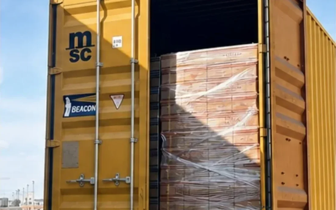 Palletized supplier cargo wrapped and loaded as one consolidated shipment inside a container
