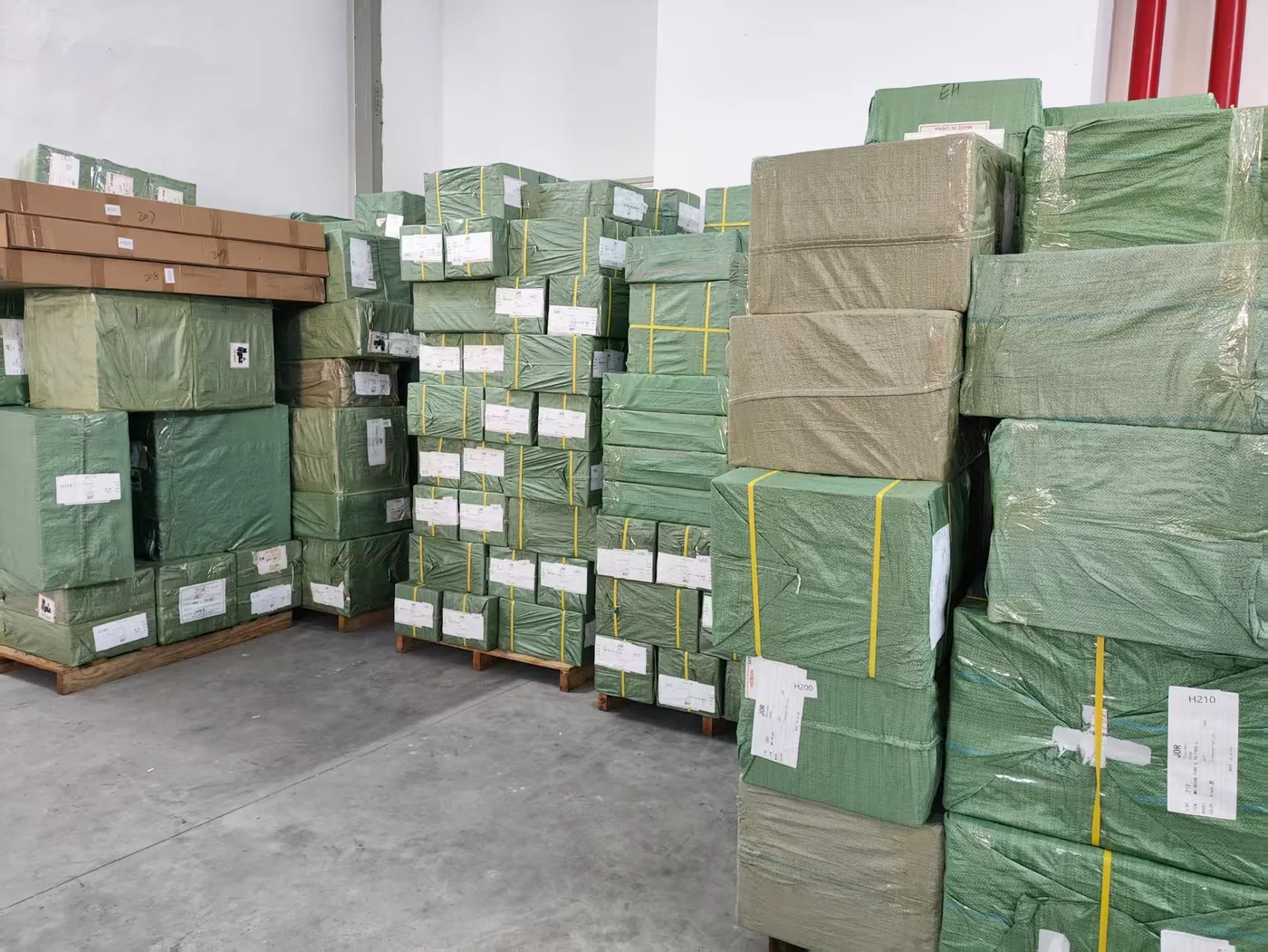 Wrapped and labelled cargo bales stacked on pallets in the consolidation warehouse