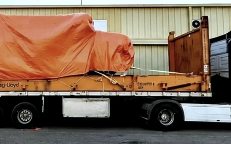 Heavy cargo secured on a flat rack trailer for road transport