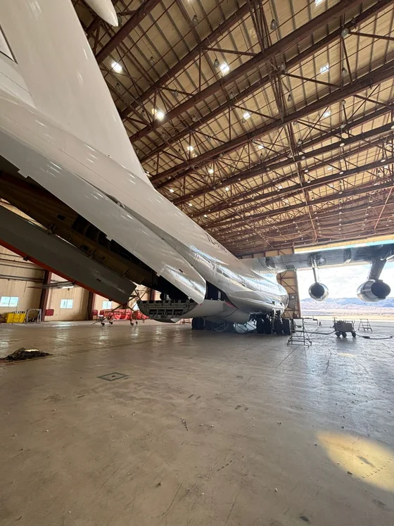Cargo aircraft in the hangar with its loading door open, ready for palletised freight