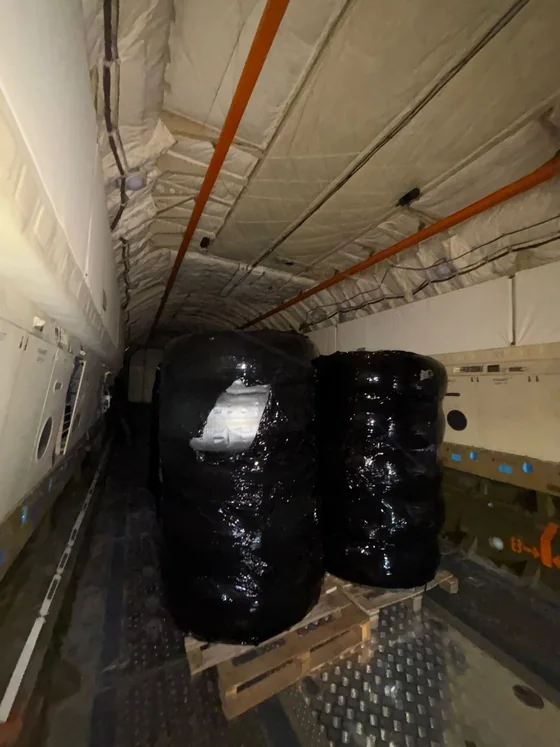 Wrapped pallets positioned and secured inside the aircraft cargo hold