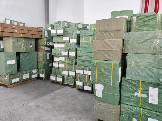 Wrapped and labelled cargo bales stacked on pallets in the consolidation warehouse