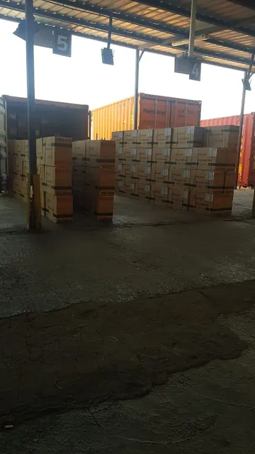 Cartons staged for customs inspection beside open containers