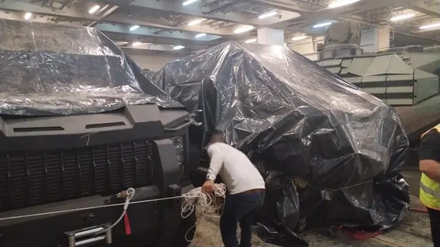 Covered vehicles lashed on a RoRo vessel deck