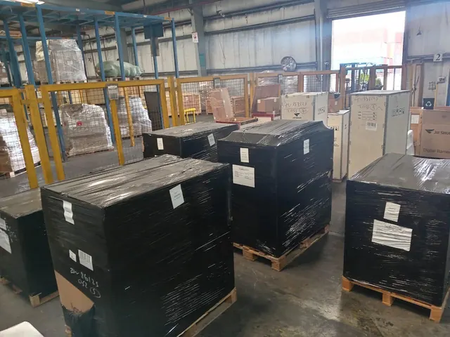 Shrink-wrapped pallets labelled and staged at the cargo terminal
